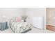 Bedroom featuring patterned bedding, neutral walls, and closet space at 1555 Water Vista Ct # 4102, Cumming, GA 30041