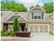 Charming home featuring a two-car garage and beautifully landscaped front yard at 1555 Water Vista Ct # 4102, Cumming, GA 30041