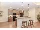 Kitchen featuring wooden cabinets, granite counters and bar seating at 1555 Water Vista Ct # 4102, Cumming, GA 30041