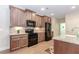 Kitchen with stainless steel appliances, tile backsplash, and wood cabinets at 1555 Water Vista Ct # 4102, Cumming, GA 30041