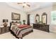 Well-decorated bedroom featuring a tray ceiling, ceiling fan, and matching dark furniture set at 1555 Water Vista Ct # 4102, Cumming, GA 30041