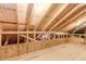 Unfinished room featuring exposed beams, wood sheathing, and insulation at 1555 Water Vista Ct # 4102, Cumming, GA 30041