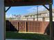 View of a backyard with a wooden fence enclosing the space and row houses in the background at 2335 Portrush Way (Lot 26) Dr, Atlanta, GA 30339