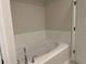 Elegant bathroom featuring a soaking tub with white subway tile backsplash and polished chrome fixtures at 2335 Portrush Way (Lot 26) Dr, Atlanta, GA 30339