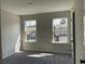 Bright bedroom with neutral walls, carpet and two large windows overlooking neighborhood homes at 2335 Portrush Way (Lot 26) Dr, Atlanta, GA 30339