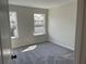 Neutral-toned bedroom featuring plush carpeting and large windows offering natural light at 2335 Portrush Way (Lot 26) Dr, Atlanta, GA 30339