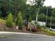 Stone and wood entrance with manicured landscaping, leading to a private property at 2335 Portrush Way (Lot 26) Dr, Atlanta, GA 30339