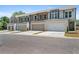 Row of modern townhomes with brick and siding exteriors, each featuring a two-car garage and landscaped front yards at 2335 Portrush Way (Lot 26) Dr, Atlanta, GA 30339