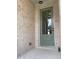 Close-up of a charming front door with glass panel, set in a brick entryway with modern outdoor lighting at 2335 Portrush Way (Lot 26) Dr, Atlanta, GA 30339