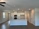 Open-concept kitchen features white cabinets, stainless appliances, and an island with a sink and countertop seating at 2335 Portrush Way (Lot 26) Dr, Atlanta, GA 30339