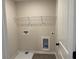Efficient laundry room with ample shelving, tiled floor, and utility connections at 2335 Portrush Way (Lot 26) Dr, Atlanta, GA 30339