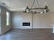 Open living space with modern chandelier, fireplace, and hardwood floors offers spacious and modern aesthetic at 2335 Portrush Way (Lot 26) Dr, Atlanta, GA 30339