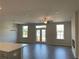 Spacious living room features hardwood floors, a fireplace, and double doors that provide access to a deck at 2335 Portrush Way (Lot 26) Dr, Atlanta, GA 30339