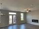 Bright living room with hardwood floors, fireplace, and double doors leading to the outdoor deck at 2335 Portrush Way (Lot 26) Dr, Atlanta, GA 30339