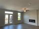 Bright living room with hardwood floors, modern fireplace, and sliding doors leading to a private balcony at 2335 Portrush Way (Lot 26) Dr, Atlanta, GA 30339