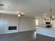 Open-concept living space with a fireplace and a modern kitchen featuring an island with bar seating at 2335 Portrush Way (Lot 26) Dr, Atlanta, GA 30339
