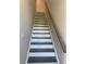 Modern staircase with dark wood treads, white risers, and a wooden handrail leading to the upper level at 2335 Portrush Way (Lot 26) Dr, Atlanta, GA 30339