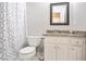 Clean bathroom featuring granite vanity, white cabinets, and stylish shower curtain at 3161 Pagoda Trce, Lawrenceville, GA 30043