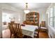Formal dining room with wood floors, crown molding, and large china cabinet, perfect for entertaining at 3161 Pagoda Trce, Lawrenceville, GA 30043