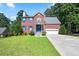 Charming two-story brick home with blue shutters, well-maintained lawn, and attached two-car garage at 3161 Pagoda Trce, Lawrenceville, GA 30043