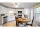 Bright kitchen featuring white cabinets, stainless steel appliances, and an eat-in breakfast nook at 3161 Pagoda Trce, Lawrenceville, GA 30043