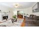 Bright living room with hardwood floors, fireplace, and views into the adjacent dining area at 3161 Pagoda Trce, Lawrenceville, GA 30043