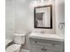 Well-lit bathroom with a single vanity, grey cabinetry, and updated fixtures, offering a functional and clean space at 4831 Miller Hill Rd, Buford, GA 30518