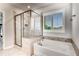 Modern bathroom with a glass enclosed shower and separate soaking tub, complemented by stylish fixtures and shutters at 4831 Miller Hill Rd, Buford, GA 30518
