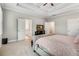 Spacious bedroom featuring tray ceilings, plush carpeting, and access to the luxurious ensuite bathroom at 4831 Miller Hill Rd, Buford, GA 30518