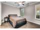 Comfortable bedroom with hardwood floors, crown molding and neutral paint, offering a relaxing retreat at 4831 Miller Hill Rd, Buford, GA 30518