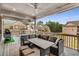This covered patio deck has an outdoor table with an outdoor kitchen in the background at 4831 Miller Hill Rd, Buford, GA 30518
