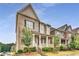 Side view of a well-maintained home with a covered porch, brick and siding exterior, and landscaped front yard at 4831 Miller Hill Rd, Buford, GA 30518