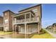 Rear exterior view of a brick home with a covered deck and three-car garage at 4831 Miller Hill Rd, Buford, GA 30518