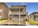 Back exterior view of a brick home with a covered patio deck and three-car garage at 4831 Miller Hill Rd, Buford, GA 30518