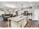 Open kitchen with a center island, stainless steel appliances, and seamless flow into the dining and living areas at 4831 Miller Hill Rd, Buford, GA 30518
