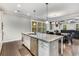 Open-concept kitchen with granite countertops, stainless steel appliances, and a large island with seating at 4831 Miller Hill Rd, Buford, GA 30518