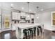 Well-lit kitchen featuring a large island with barstool seating, stainless steel appliances, and pendant lighting at 4831 Miller Hill Rd, Buford, GA 30518