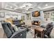 Inviting living room with fireplace, built-in shelves, coffered ceilings and open concept design leading to kitchen at 4831 Miller Hill Rd, Buford, GA 30518