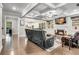 Comfortable living room with a fireplace, coffered ceiling, built-in shelving, and hardwood flooring throughout at 4831 Miller Hill Rd, Buford, GA 30518