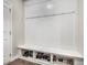 This mudroom has a bench and hooks with storage for shoes underneath at 4831 Miller Hill Rd, Buford, GA 30518