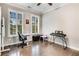 Bright home office with hardwood floors, plantation shutters, and ample space for a desk and keyboard at 4831 Miller Hill Rd, Buford, GA 30518