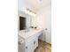 This bathroom has a vanity with decorative lighting, a large framed mirror and storage at 307 Berkeley Woods Dr, Duluth, GA 30096