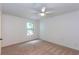 This bedroom has neutral carpet, a lighted ceiling fan and a single window at 307 Berkeley Woods Dr, Duluth, GA 30096