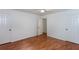 This bedroom has hardwood floors, a lighted ceiling fan, two closets and entry to other rooms at 307 Berkeley Woods Dr, Duluth, GA 30096