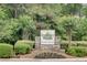 Stone entrance sign for Berkeley Woods Condominiums surrounded by manicured landscaping at 307 Berkeley Woods Dr, Duluth, GA 30096
