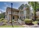 Inviting condo exterior with balcony, landscaped garden, and natural light at 307 Berkeley Woods Dr, Duluth, GA 30096