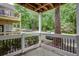 Inviting porch with black metal railings and a view of lush green trees at 307 Berkeley Woods Dr, Duluth, GA 30096