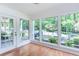 Bright sunroom with hardwood floors and serene views of the outdoors at 307 Berkeley Woods Dr, Duluth, GA 30096