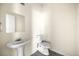 Simple bathroom with pedestal sink and toilet at 7331 Wagon Wheel Ct, Jonesboro, GA 30236