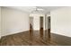 Spacious bedroom featuring wood floors and multiple doors to other rooms at 7331 Wagon Wheel Ct, Jonesboro, GA 30236